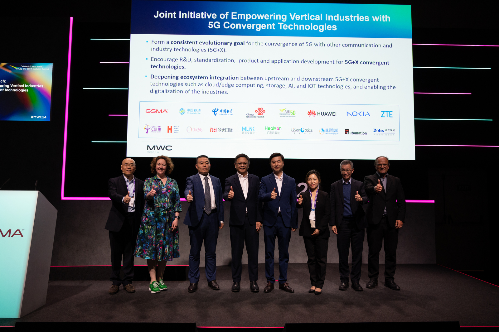 8 persons in on stage in a row 