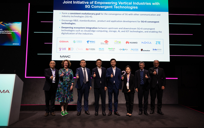 8 persons in on stage in a row 