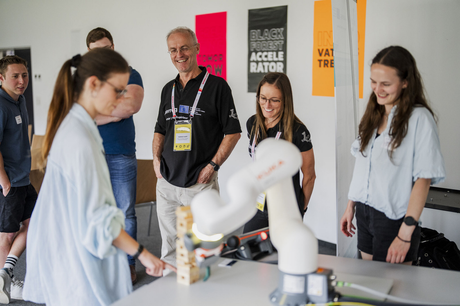  People watch a robotic arm