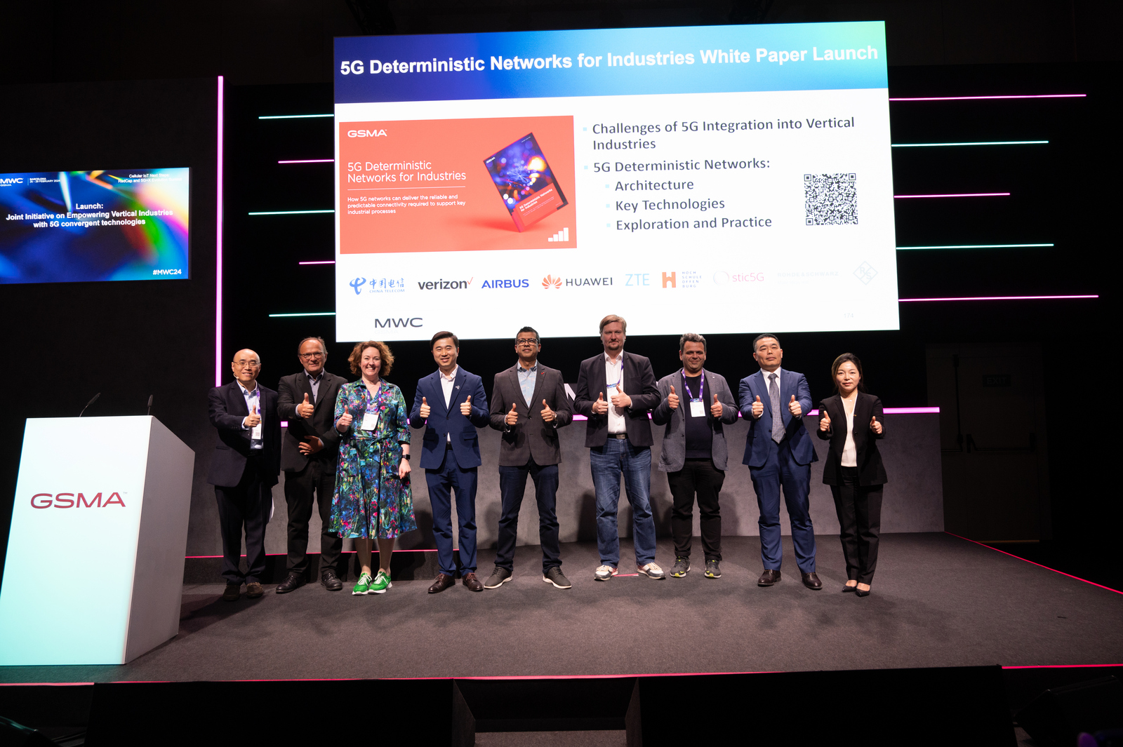 9 persons on stage in a row