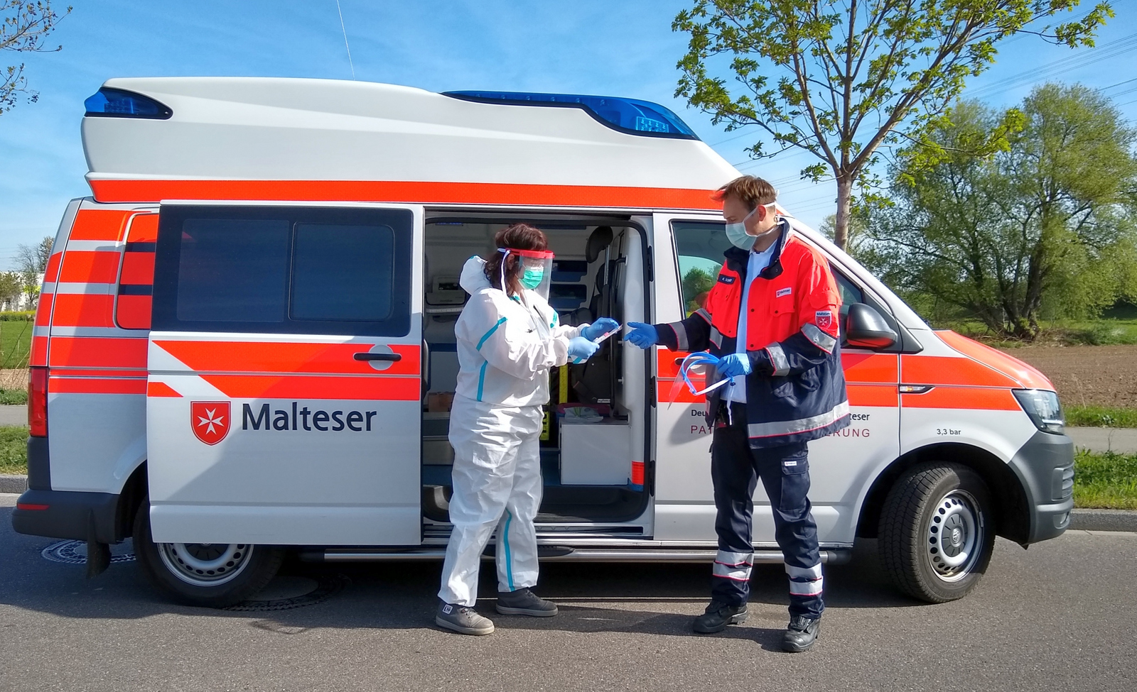 2 Personen vor Krankenwagen