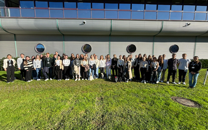 A group photo of people in front of a building