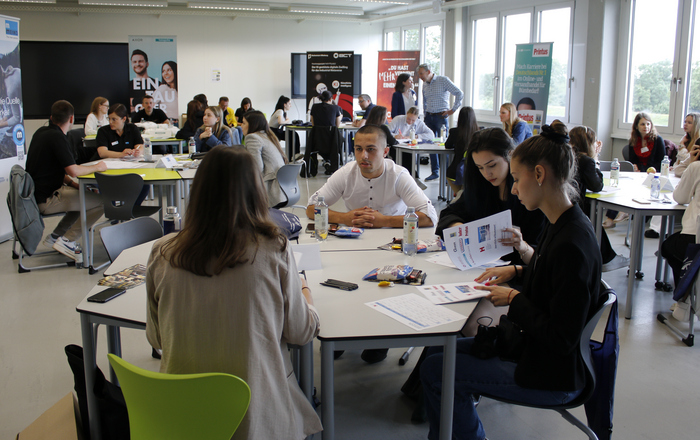 Schüler sitzen an Unternehmenstischen