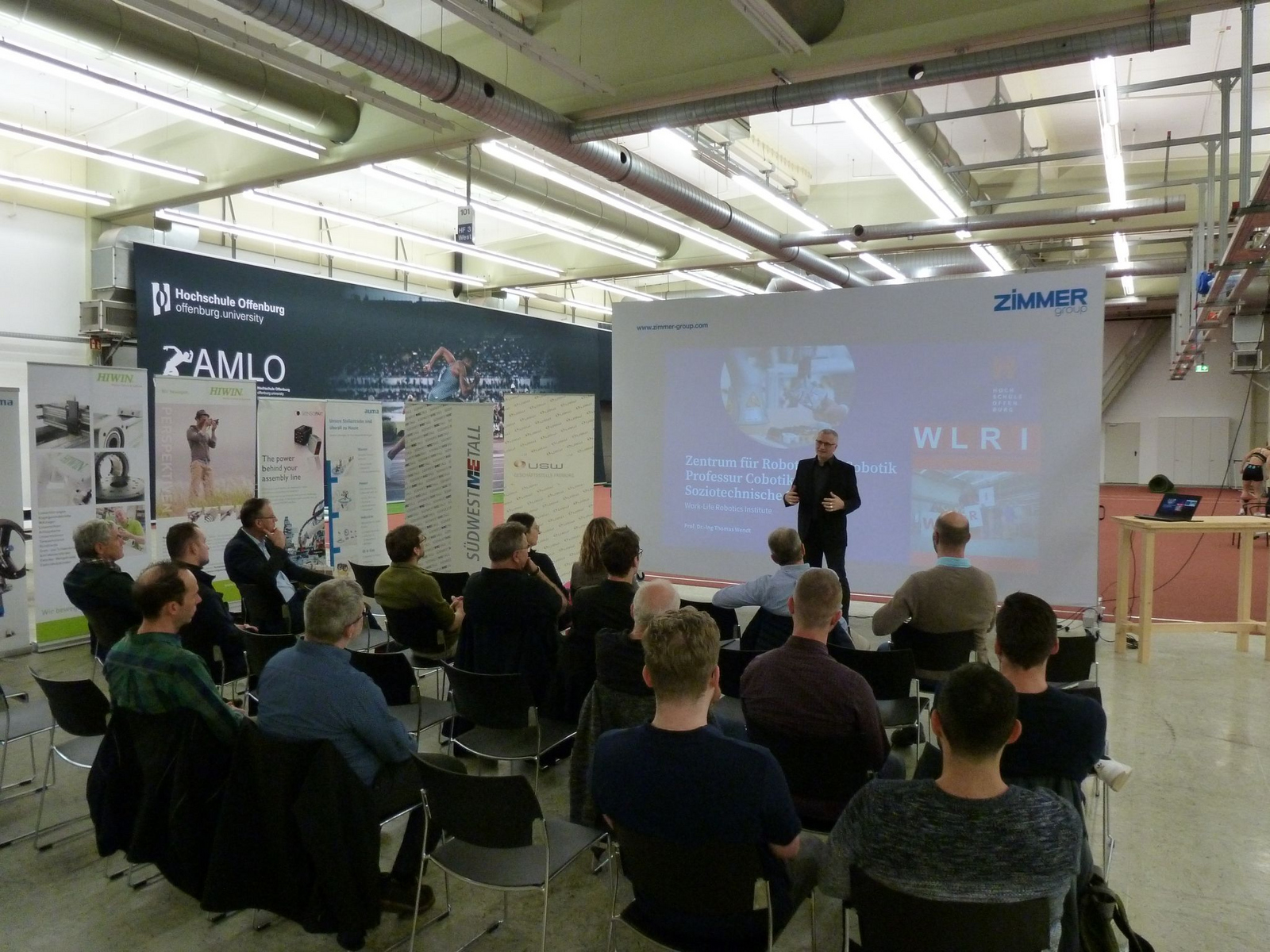 A person giving a presentation to a group of seated people